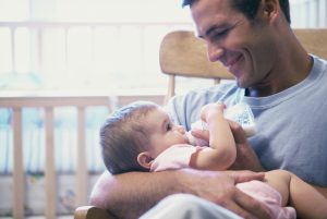 Father feeding his baby boy